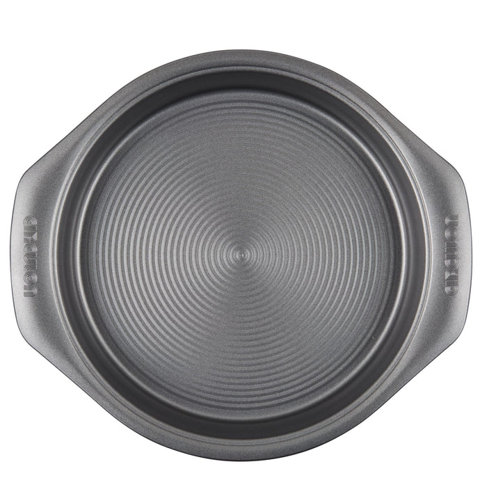 A round, ridged baking pan with side handles from the 10-Piece Nonstick Bakeware Set, designed from heavy gauge steel to offer outstanding resistance to warping.