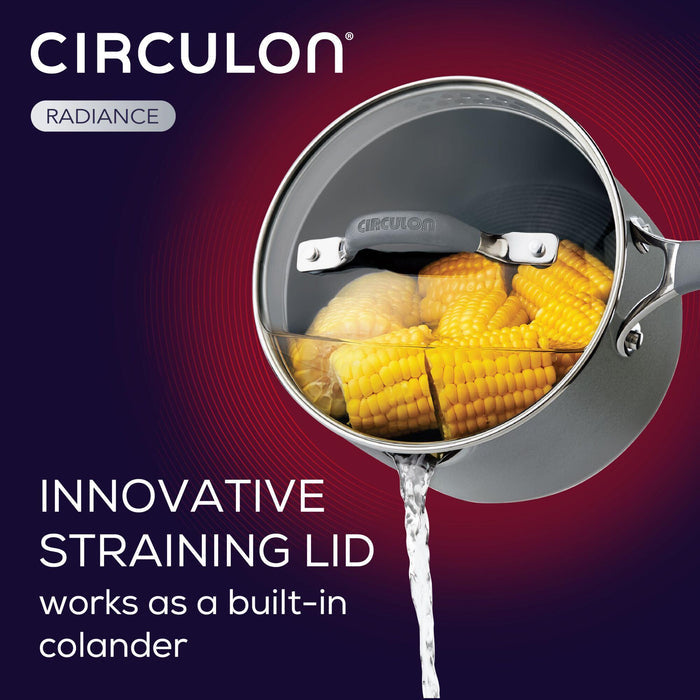 The 3-Quart Nonstick Straining Saucepan, featuring a sturdy hard-anodized construction, effortlessly drains water while securely holding corn on the cob, ensuring a seamless cooking experience.