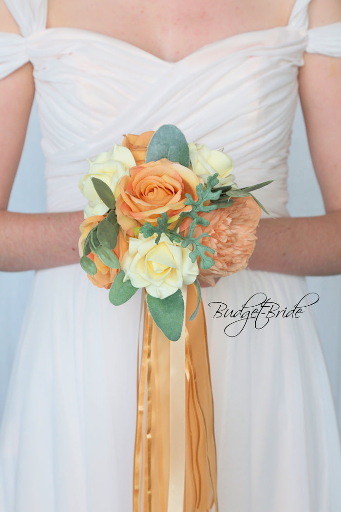 Small bridesmaid bouquet with apricot and cream roses and peonies with sage greenery and ribbon
