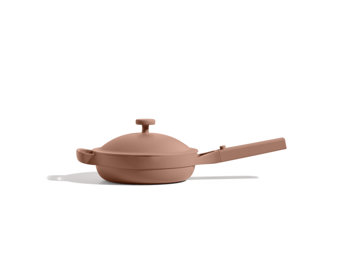 The Mini Always Pan 2.0, a cute matte light brown 8-in-1 pan with a domed lid and long handle, sits on a white background, seamlessly blending style and convenience for your kitchen.