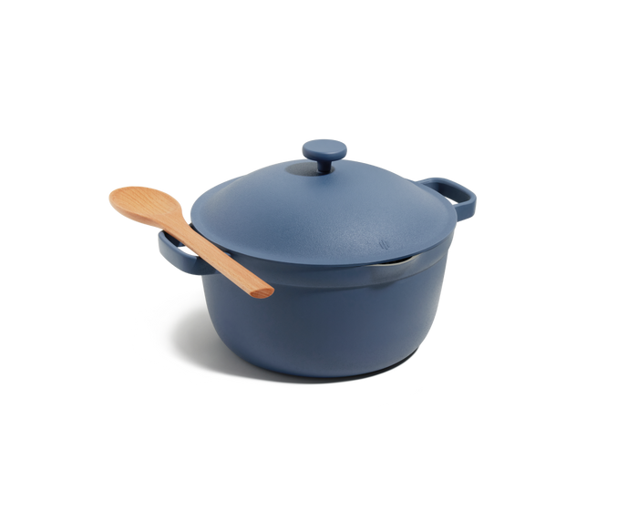The Perfect Pot, a blue family-sized pot with a matching lid and wooden spoon, is shown resting on its side against a plain white background.