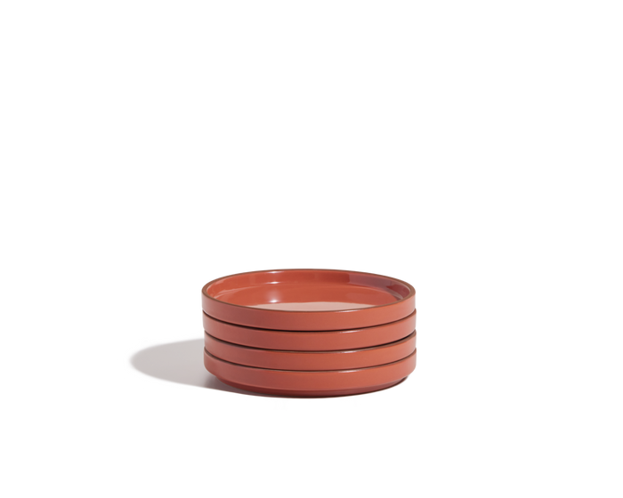 A stack of three scratch-resistant, reddish-brown Dessert Plates set against a plain white background.