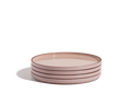 A stack of four round, hand-glazed pink Dinner Plates on a white background, perfect for adding a pop of color to your tableware collection.