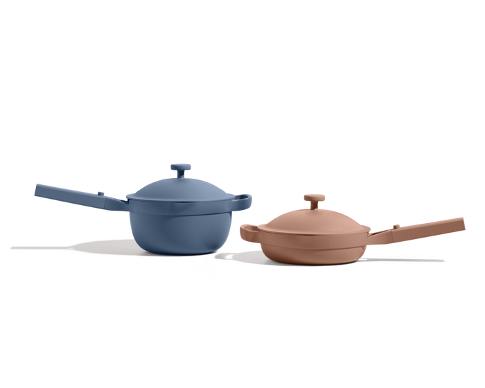 The Mini Cookware Duo, featuring the Mini Always Pan in blue and the Mini Perfect Pot in beige with lids, is displayed side by side on a white background.