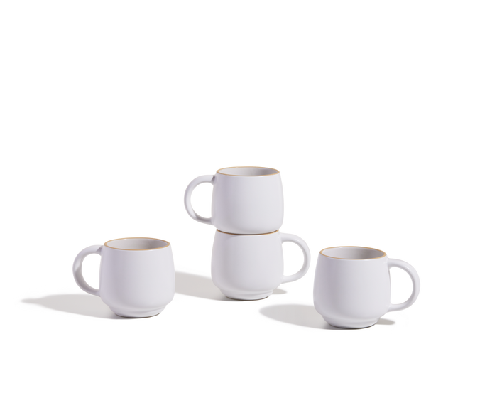 Four Night + Day Mugs are displayed on a white surface; two mugs are stacked, and two stand separately.
