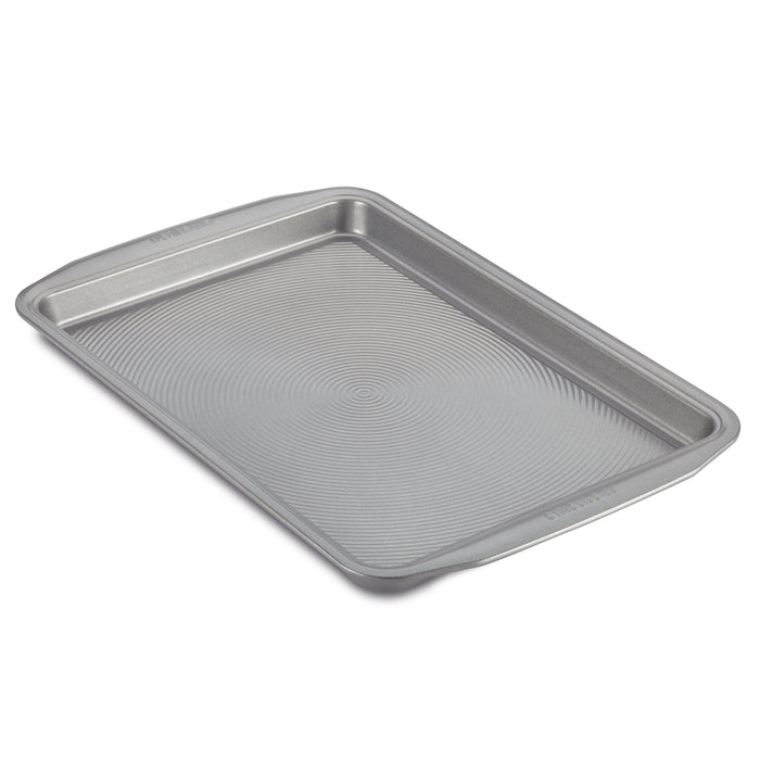 The Nonstick Cookie Pan features a rectangular metallic design with a textured bottom, ensuring easy baking and cleaning. It's oven safe to meet all your baking needs.