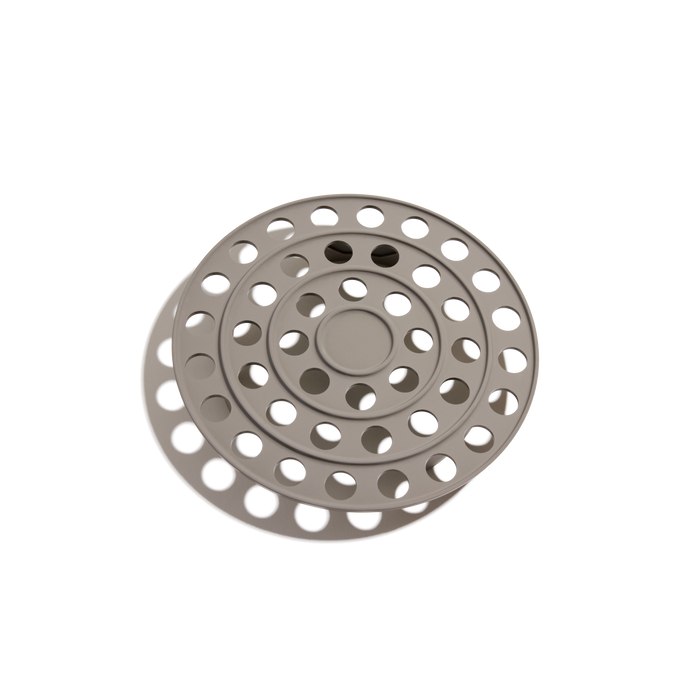The Perfect Pot Roasting Rack is a round, beige accessory with concentric rings and evenly spaced circular holes, custom-fit and displayed on a white background.