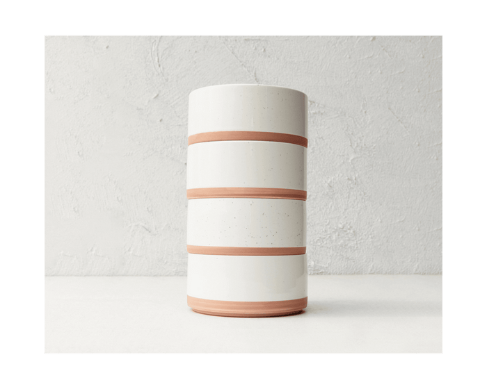 Three stackable Side Bowls with unglazed terracotta bands around their middles are arranged against a light textured background.