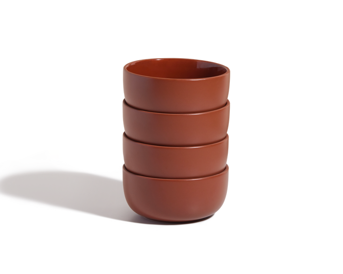Four stacked, round brown Soup Bowls on a white background—a versatile ceramic set ideal for stylish tableware collections.