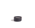 The Tiny Plates are small, round ceramic snack plates in dark gray with three horizontal ridges, displayed against a plain white background.